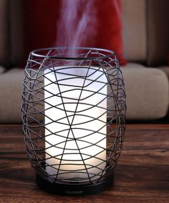 Aromasource enlighten diffuser on table with light and steam on