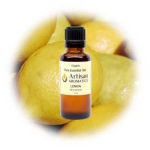 Lemon essential oil by Artisan Aromatics on a background of lemons