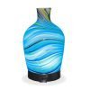 Aromar Glass Abstract Decanter Diffuser with light blue light on a white background