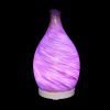 Amphora Copper Diffuser with purple light on a black background