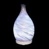 Amphora Copper Diffuser with white light on a black background