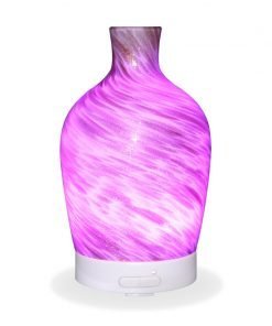 Aromar Decanter Abstract Bronze Diffuser with purple light on a white background