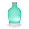 Aromar Decanter Abstract White Diffuser with green light on a white background