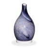 Rotating glass amphora shaped blue diffuser with no light on a white background