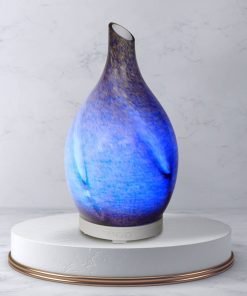 Rotating glass Amphora Blue diffuser on white pedestal