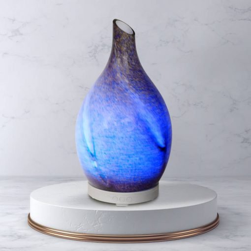 Rotating glass Amphora Blue diffuser on white pedestal