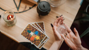 divination tools, crystal ball, tarot cards, and small cauldron 